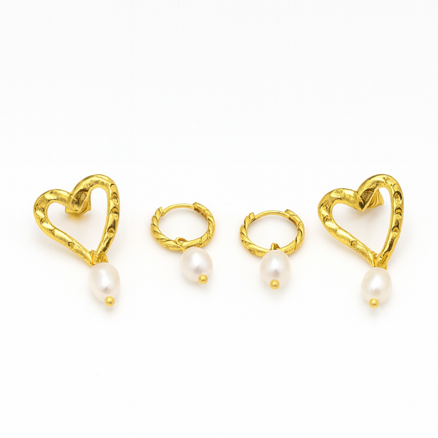 Gold heart-shaped earrings with pearls on a white background