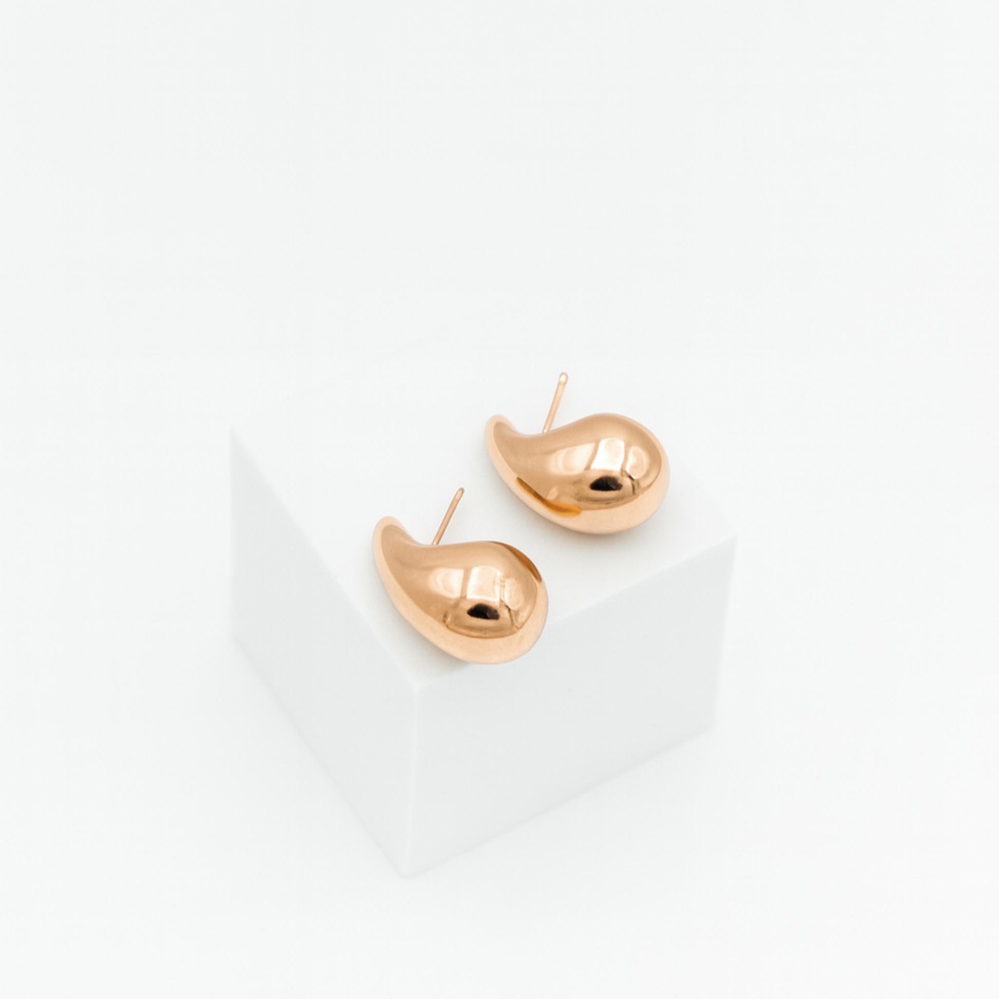 Pair of gold earrings on a white background