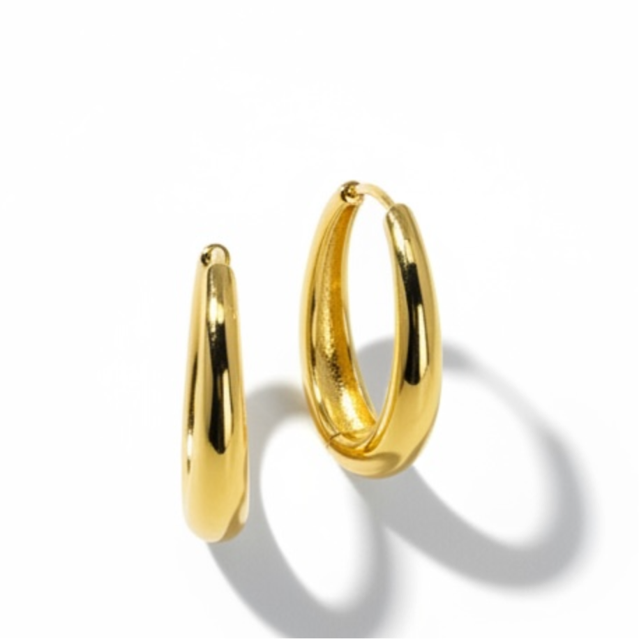 18K gold plated over brass, these polished oval hoop earrings feature a sleek, refined design with a smooth, high-shine finish.
