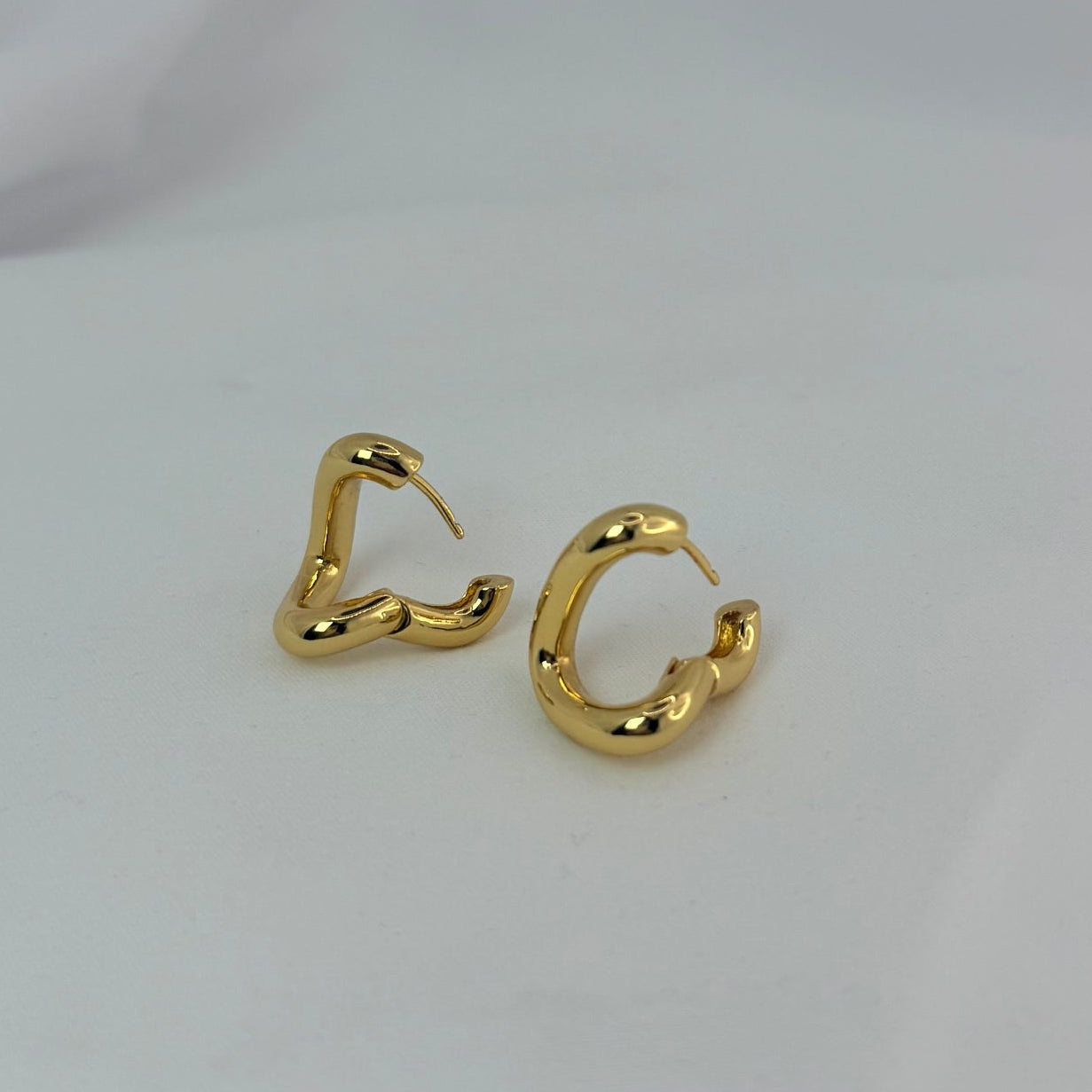 Gold hoop earrings on a white background