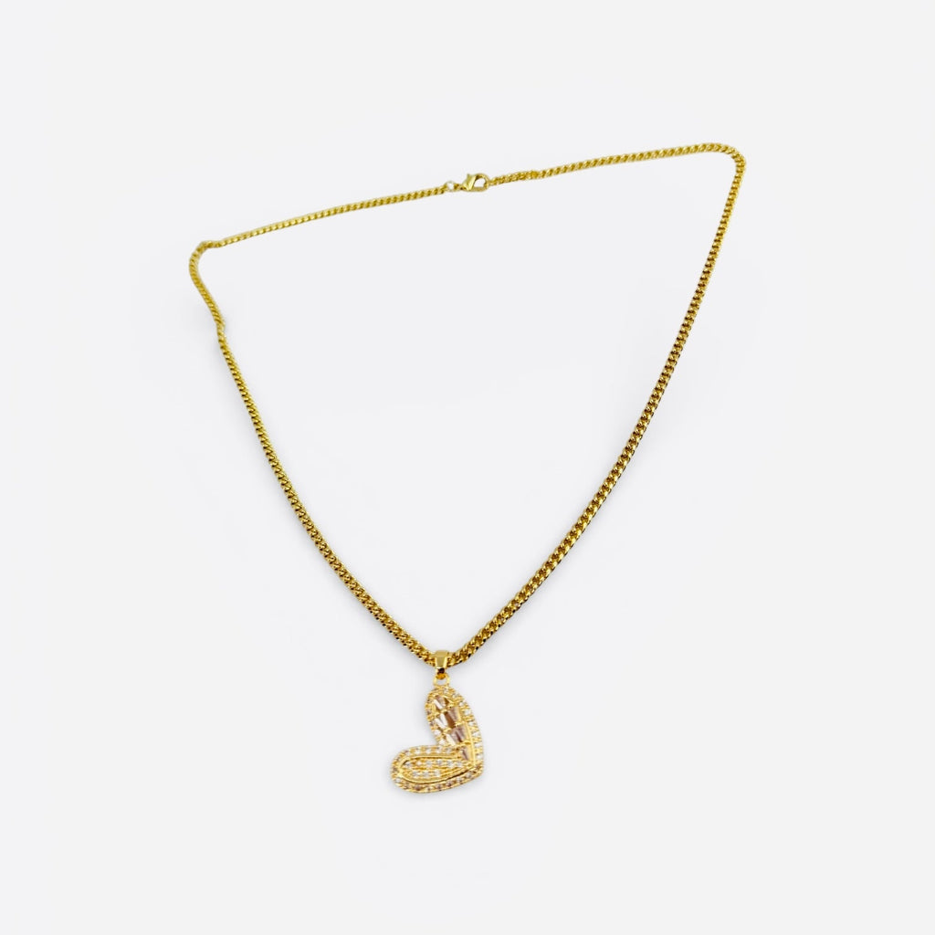 Gold necklace with a heart-shaped pendant on a white background