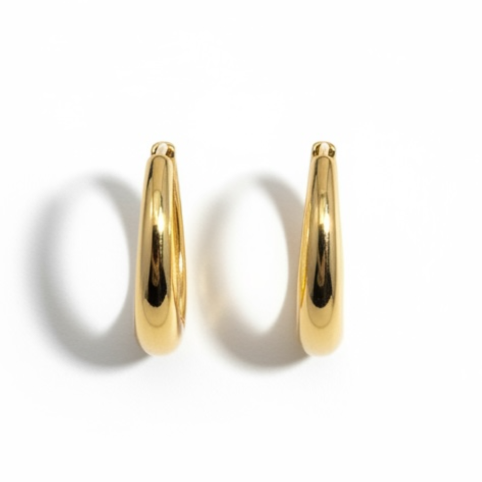 18K gold plated over brass, these polished oval hoop earrings feature a sleek, refined design with a smooth, high-shine finish.
