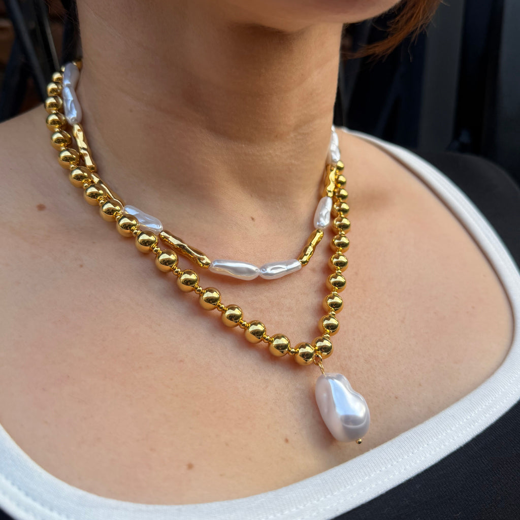 18K gold plated over brass, the Liquid Pearl Beaded Necklace offers a modern take on classic elegance.