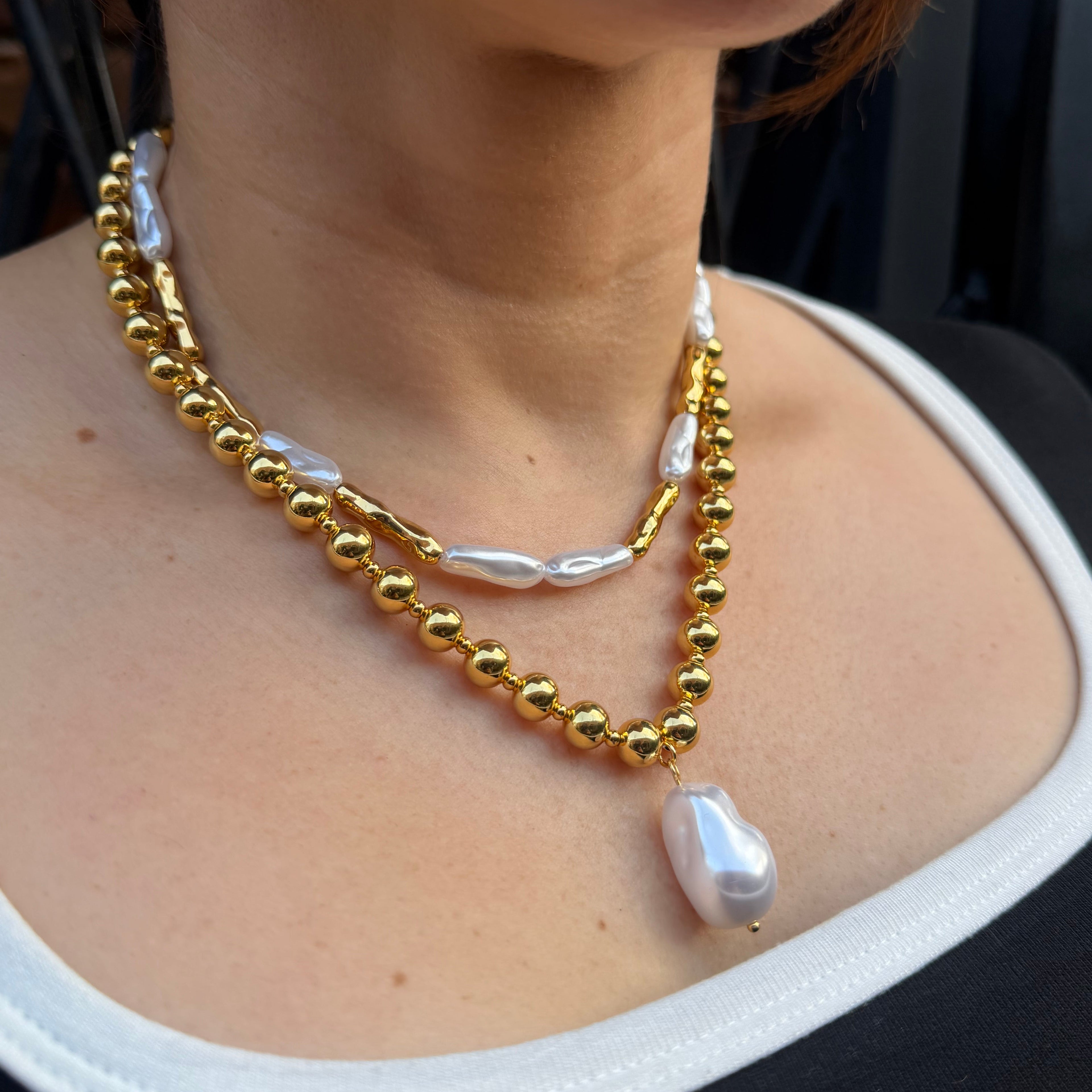 18K gold plated over brass, the Liquid Pearl Beaded Necklace offers a modern take on classic elegance.