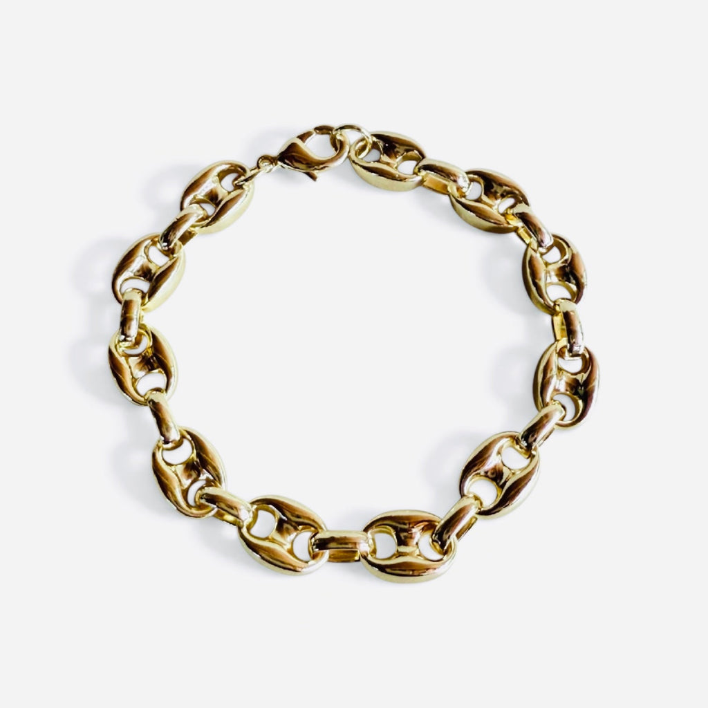 Gold chain bracelet on a white background