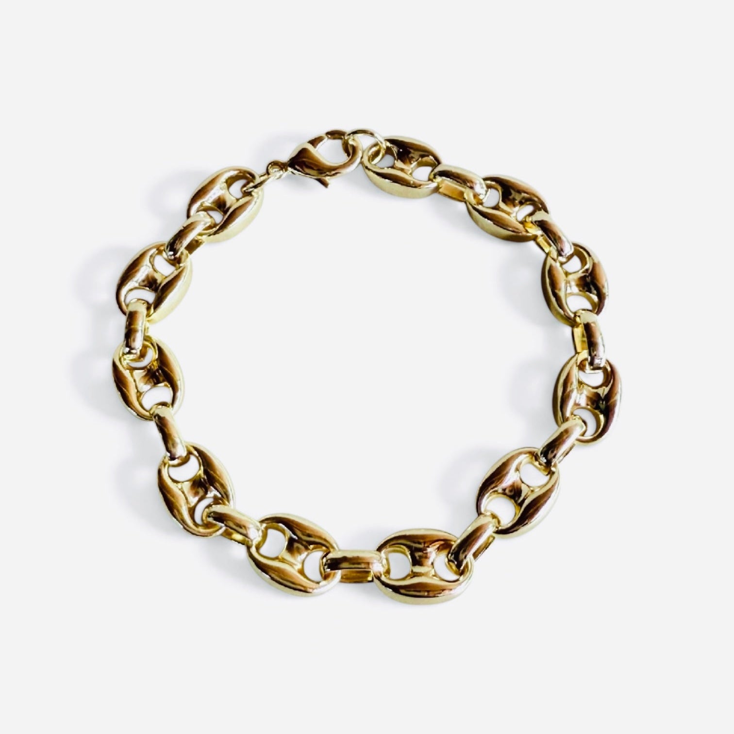 Gold chain bracelet on a white background