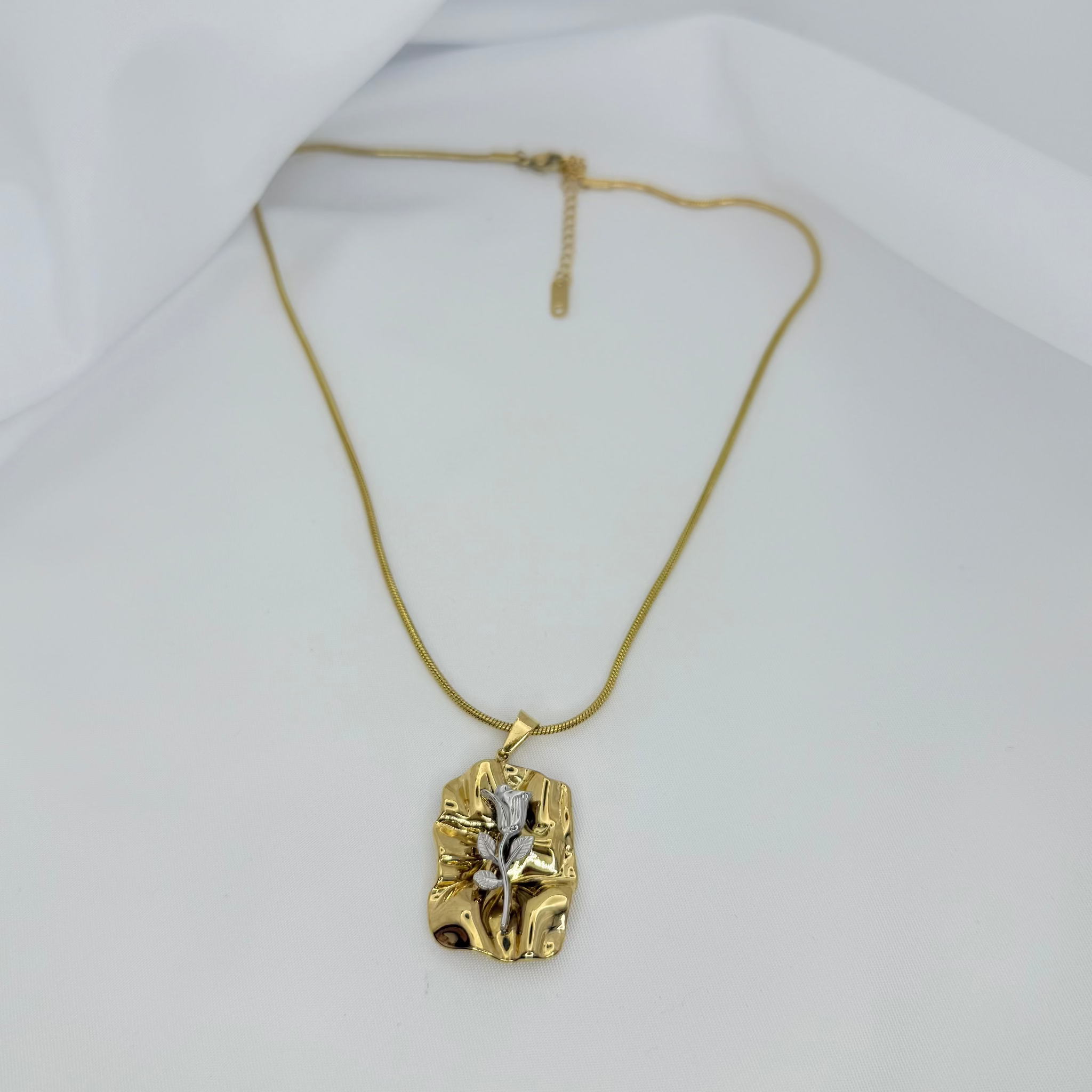 Gold pendant necklace on a white background
