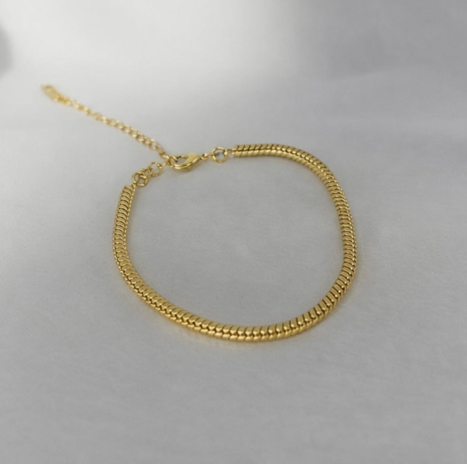 Gold bracelet on a white background
