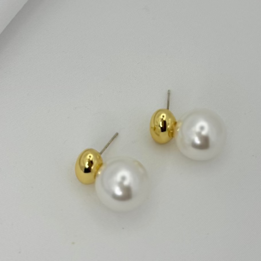 Pair of pearl earrings on a light gray background