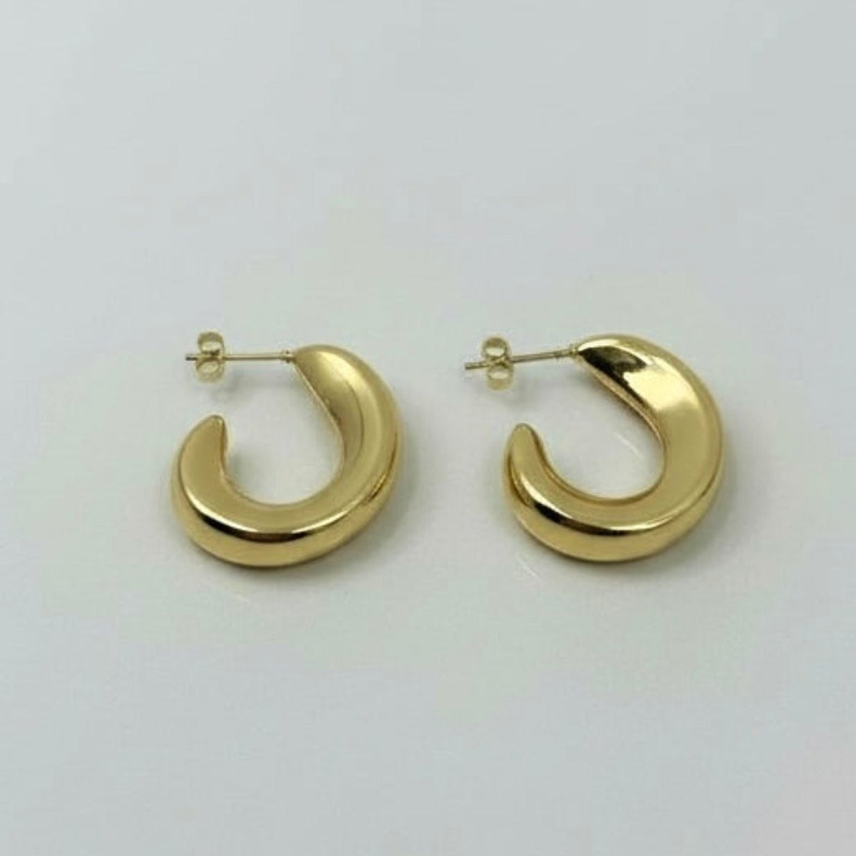 Gold hoop earrings on a white background