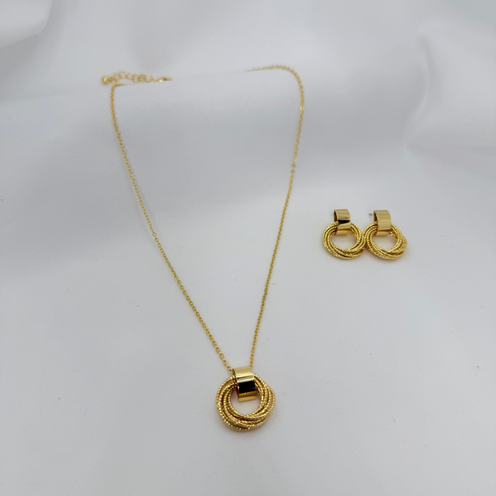 Gold necklace and earrings on a white background