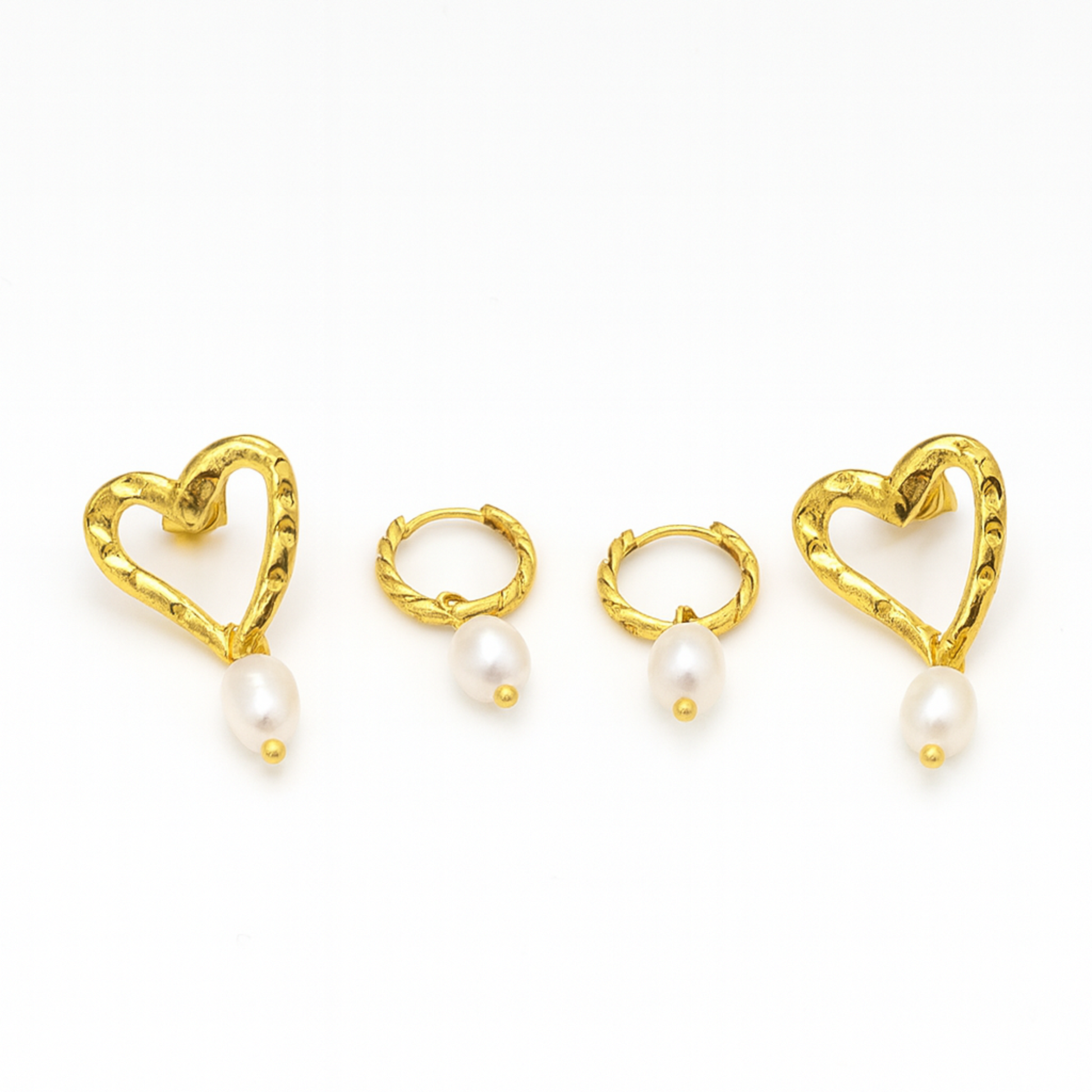 Gold heart-shaped earrings with pearls on a white background