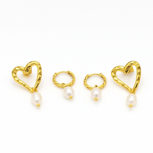 Gold heart-shaped earrings with pearls on a white background
