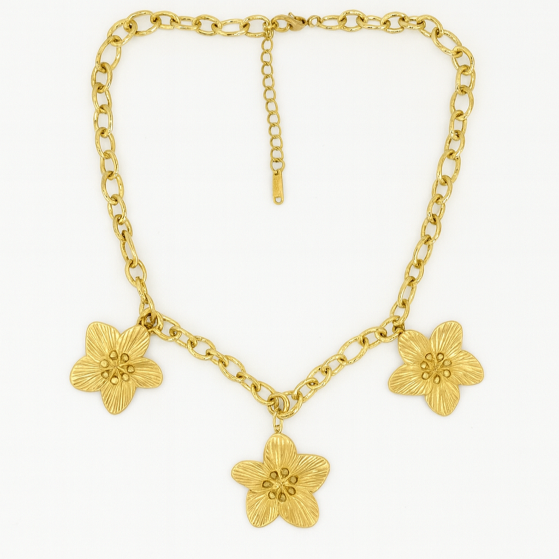 Gold chain necklace with floral pendants on a white background