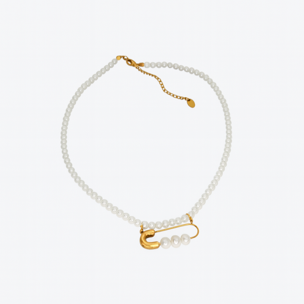 Pearl bracelet with gold clasp on a white background