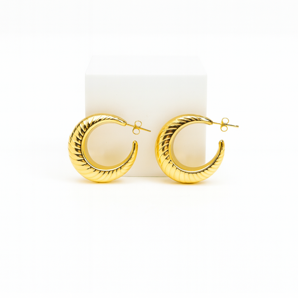Gold hoop earrings on a white background
