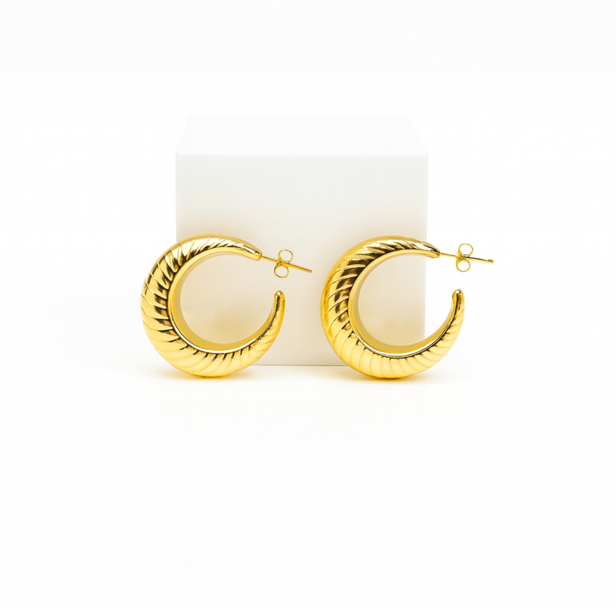 Gold hoop earrings on a white background