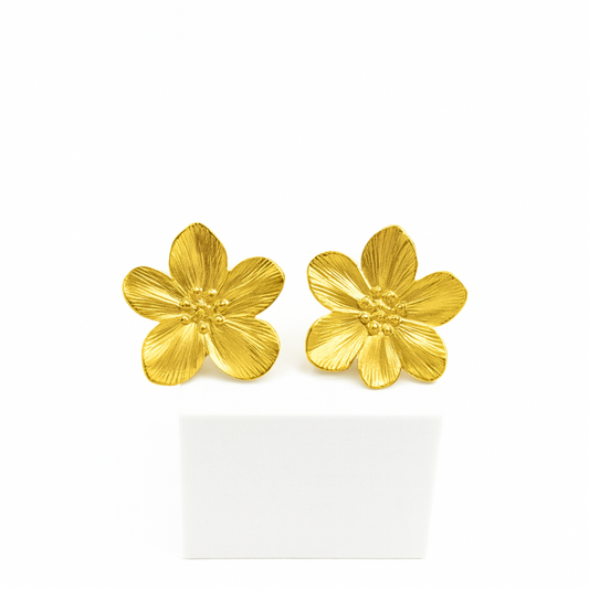 Gold flower-shaped earrings on a white background