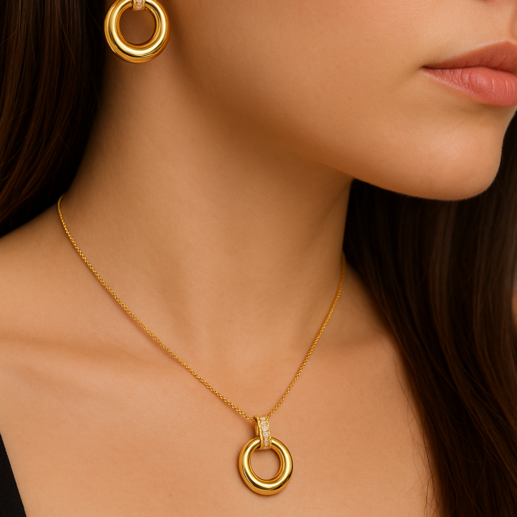 Close-up of a woman wearing gold hoop earrings and necklace.