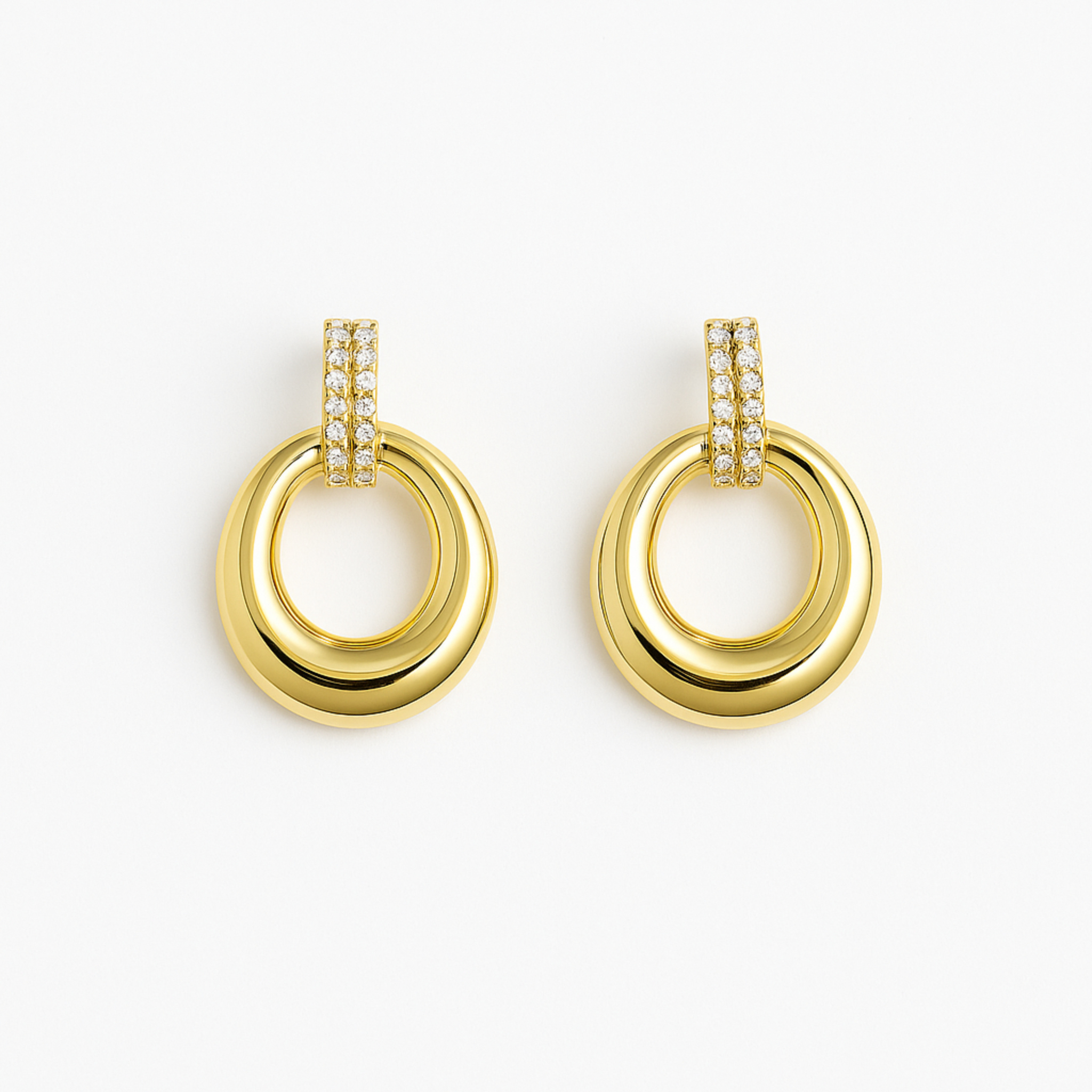 Gold hoop earrings with diamond accents on a white background