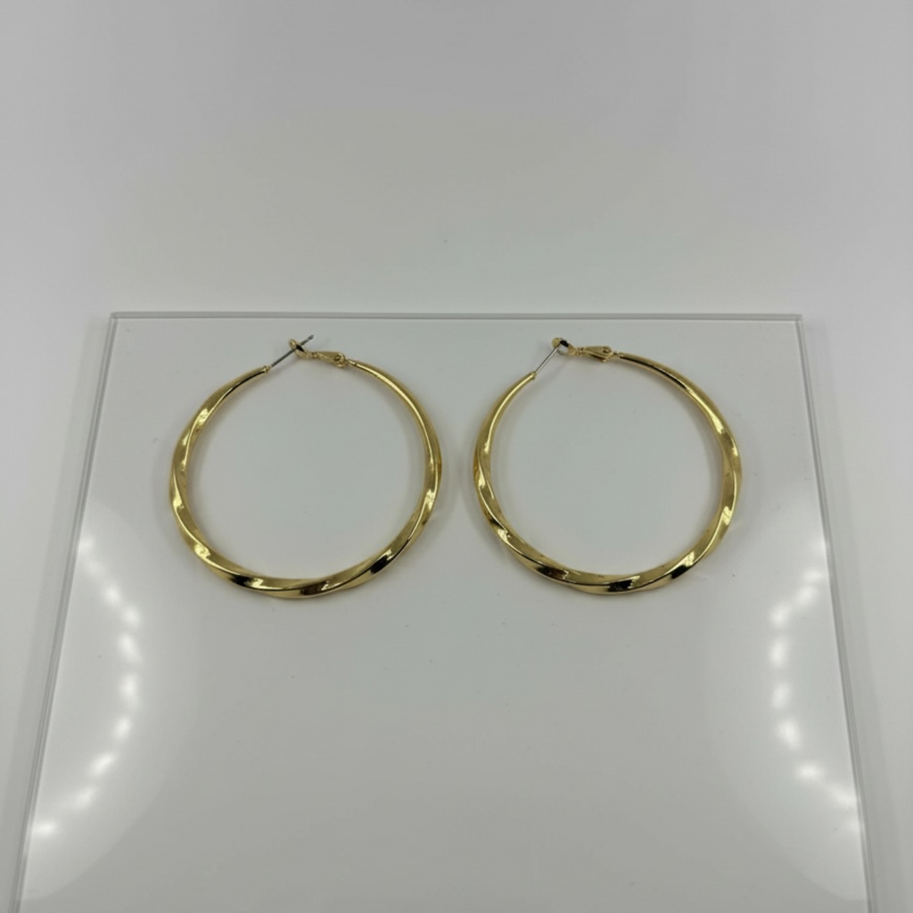 Gold hoop earrings on a white card