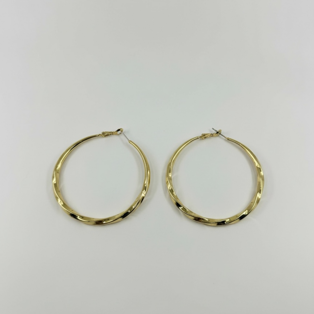 Gold hoop earrings on a light gray background