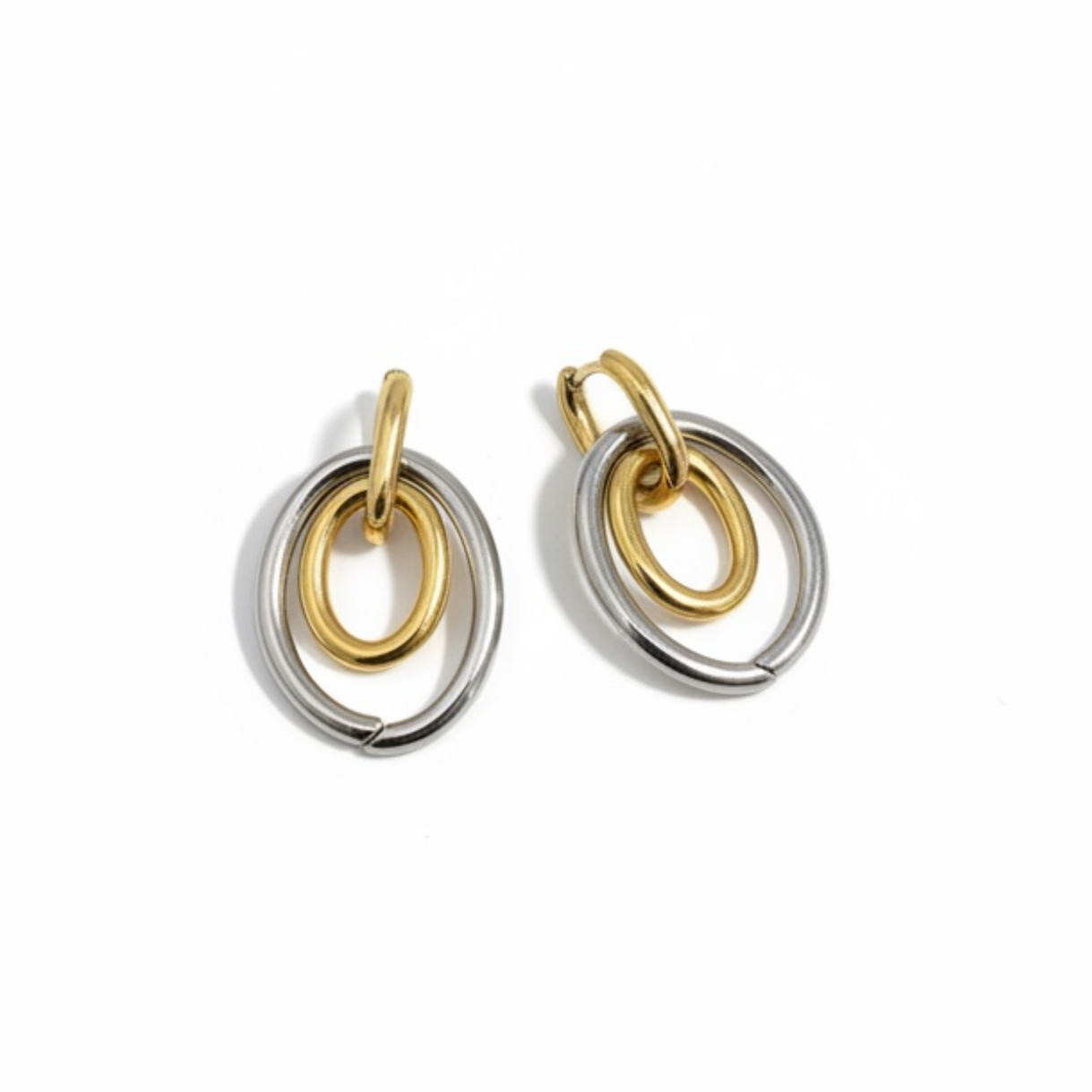 Pair of gold and silver hoop earrings on a white background