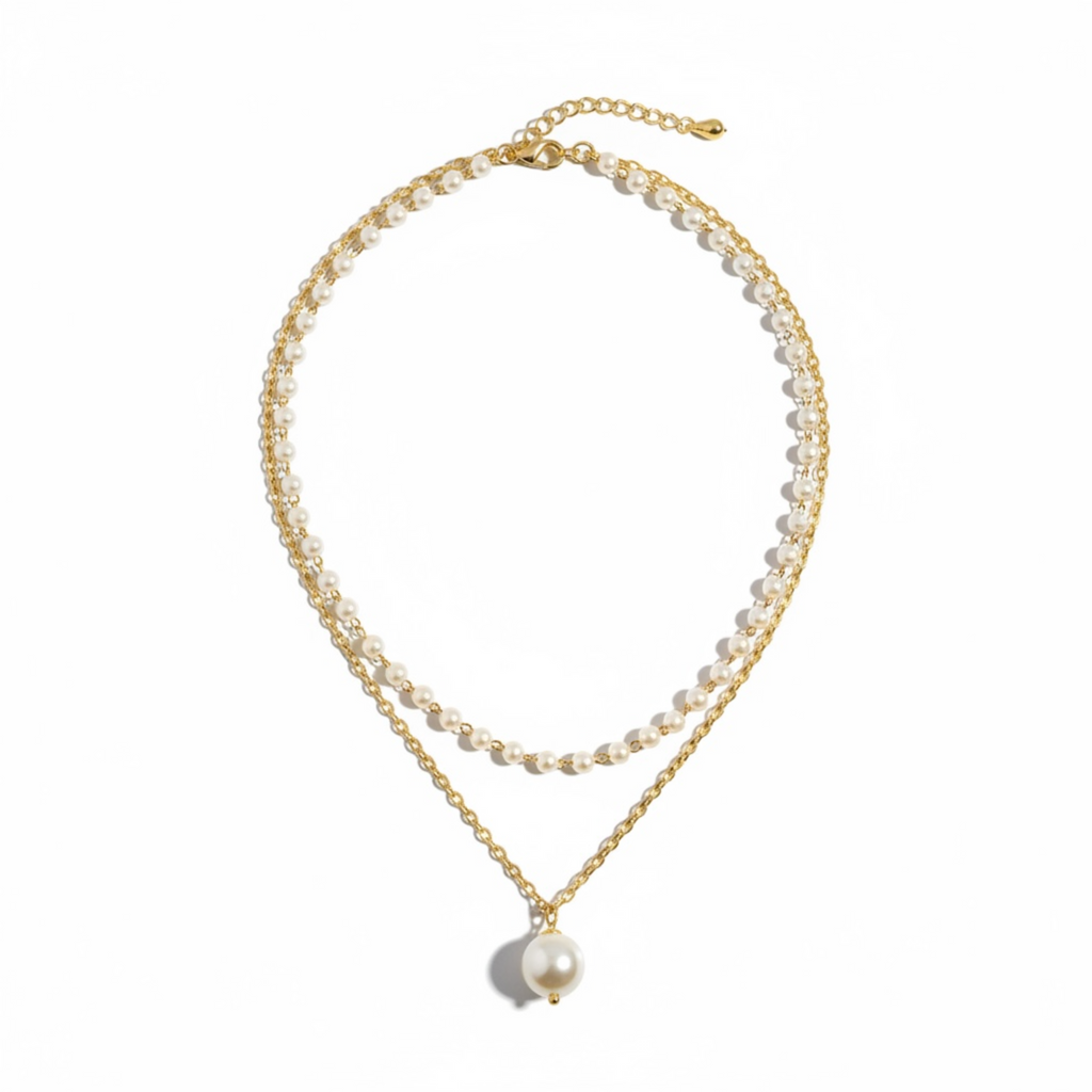 Double-layered pearl necklace with gold chain on a white background