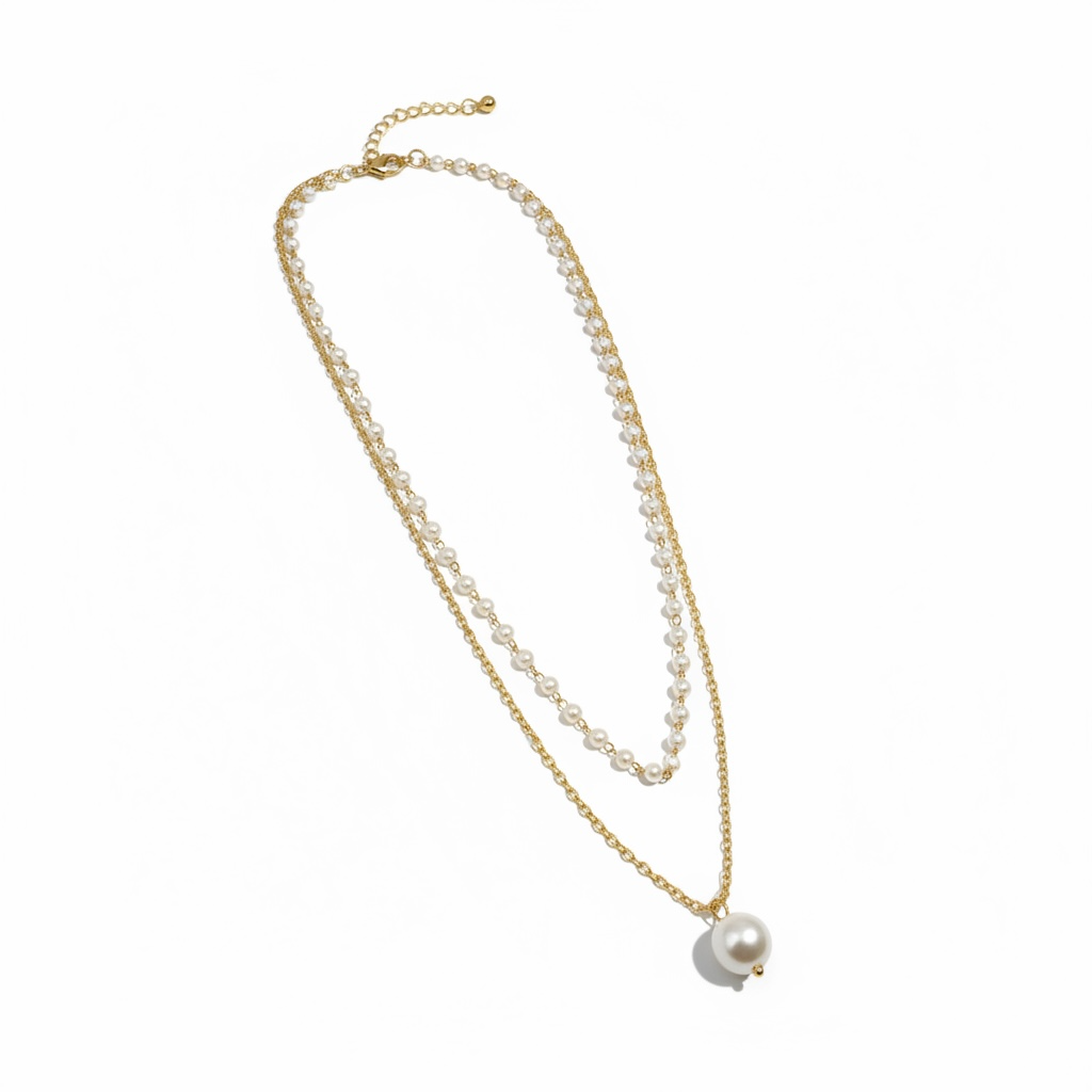 Gold necklace with a single pearl pendant on a white background