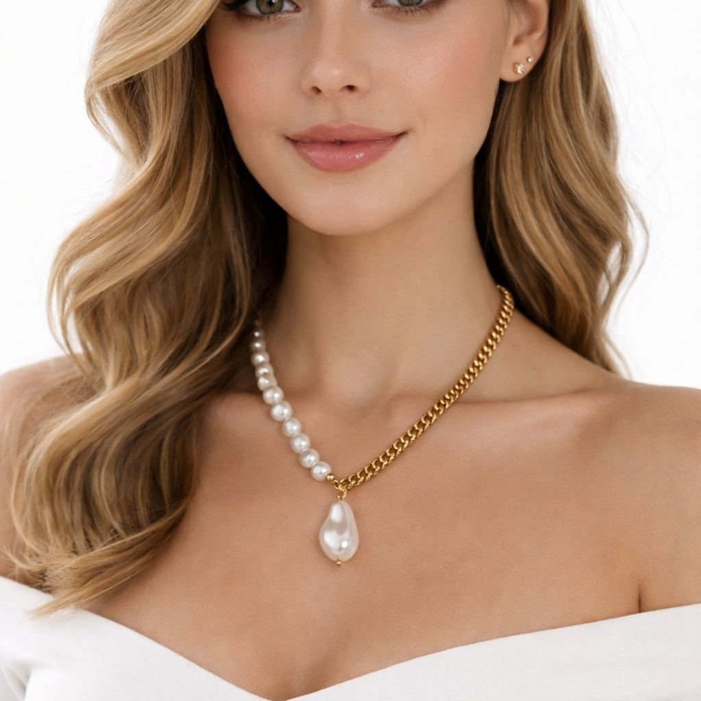 Woman wearing a pearl necklace on a white 18K gold plated over brass, the Baroque Pearl Fusion Necklace blends classic elegance with a bold, modern edge.
