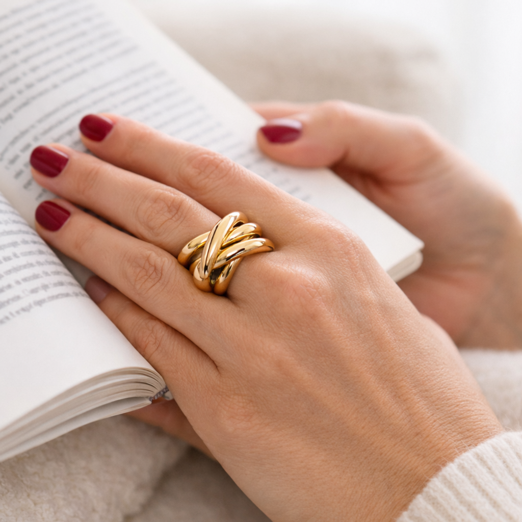 Modern Ring features a sculptural and statement Hand wearing a gold ring stainless steel