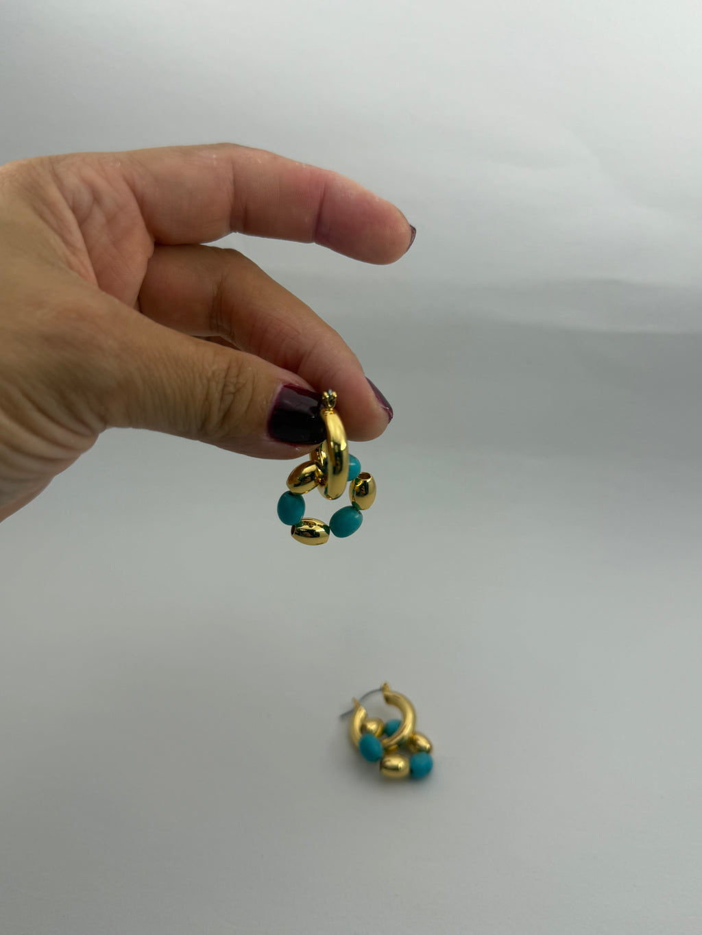 "Turquoise double hoop earrings close-up"