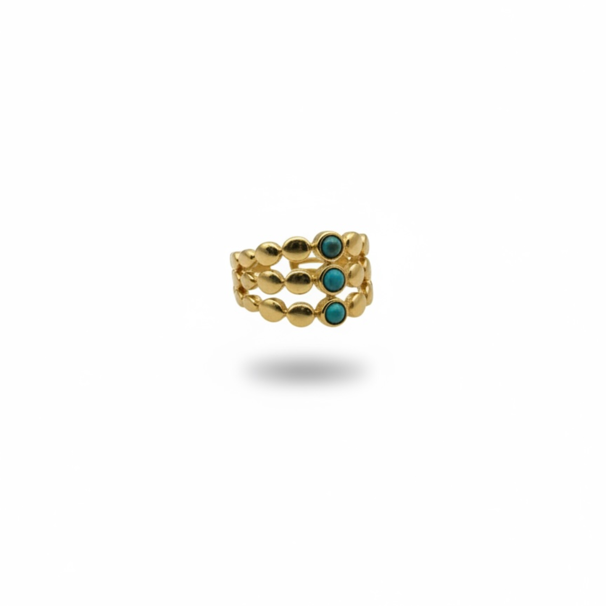 Gold ring with turquoise stones on a white background