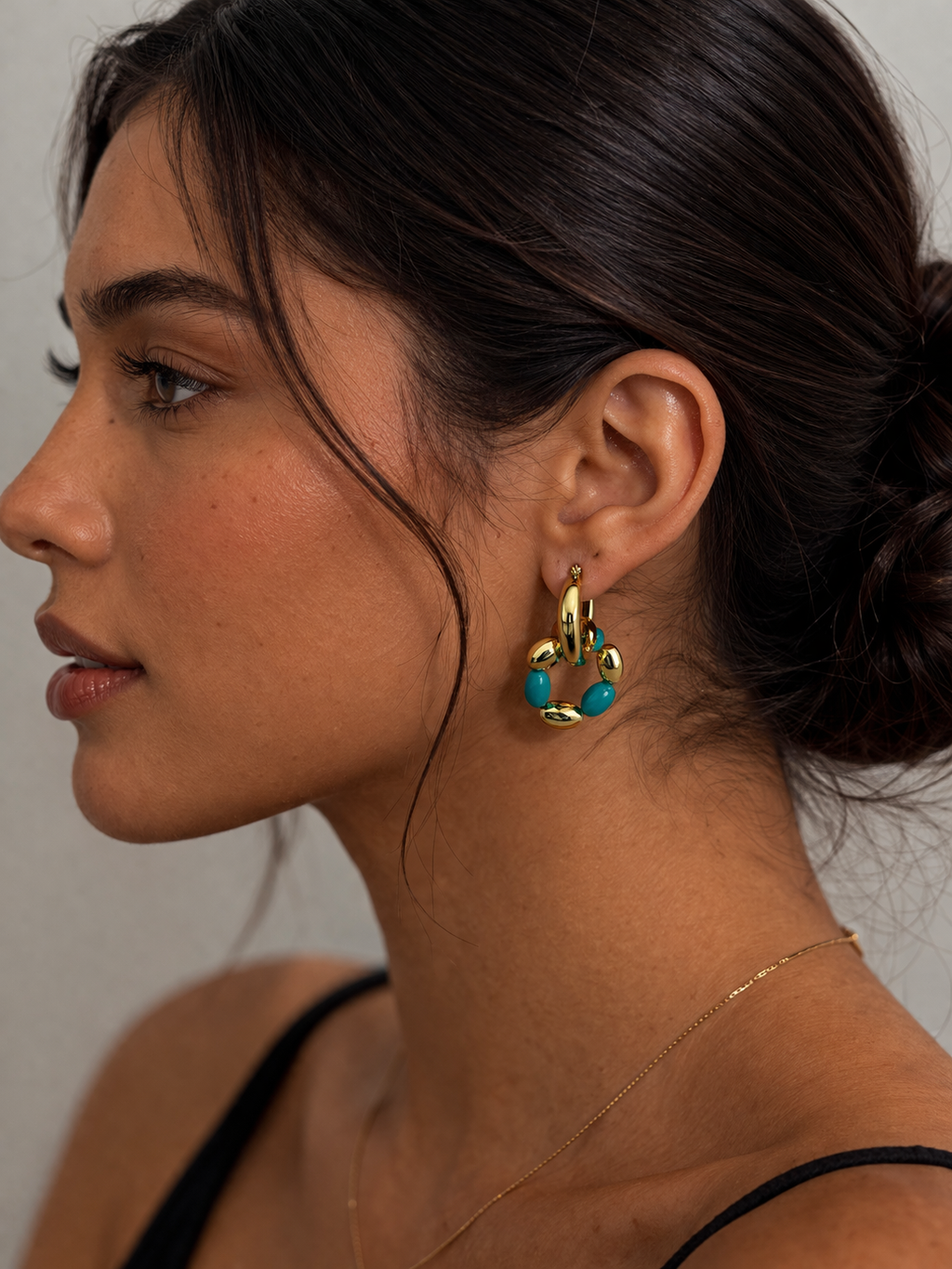 "Turquoise duo hoop earrings worn on ear"