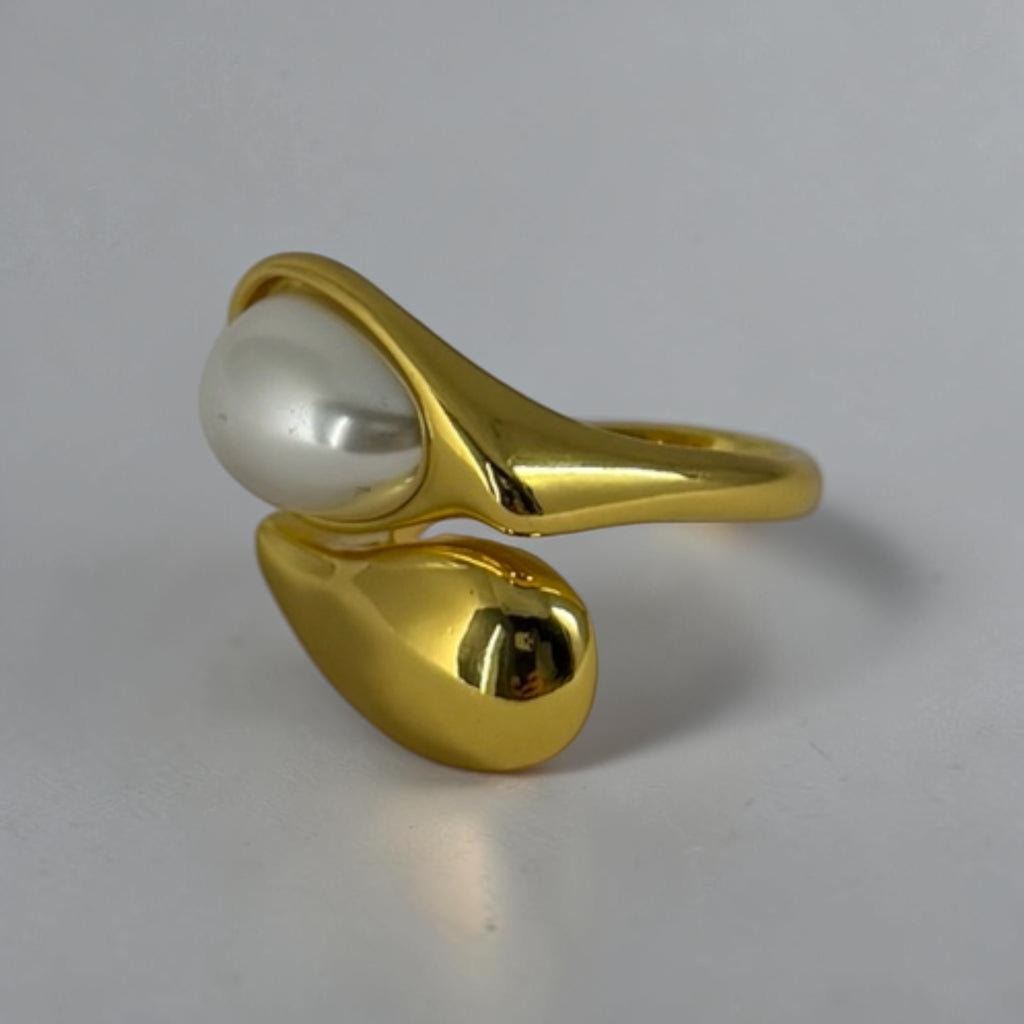 "Teardrop pearl ring side view on hand"