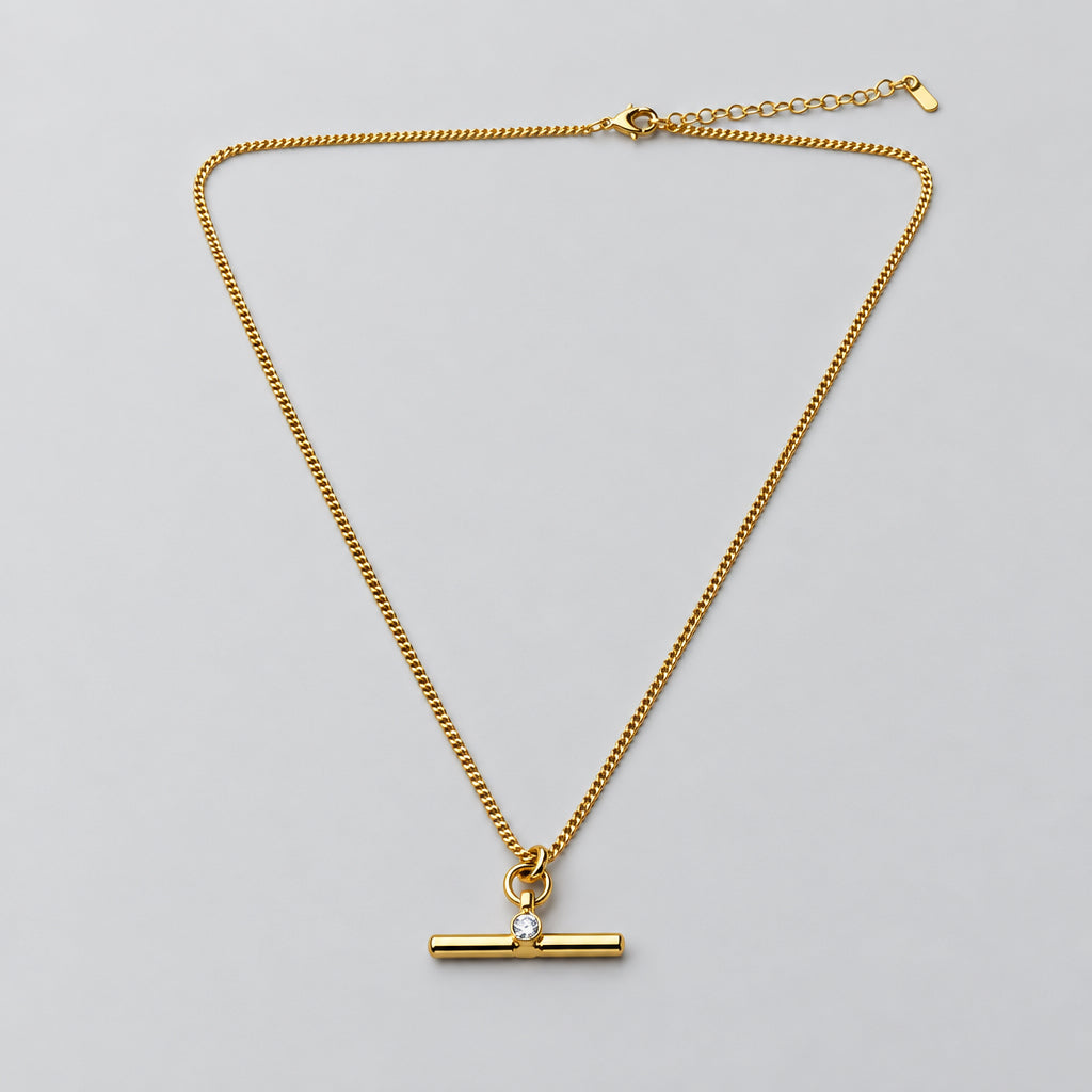 A gold-tone chain necklace with a toggle clasp pendant, 
