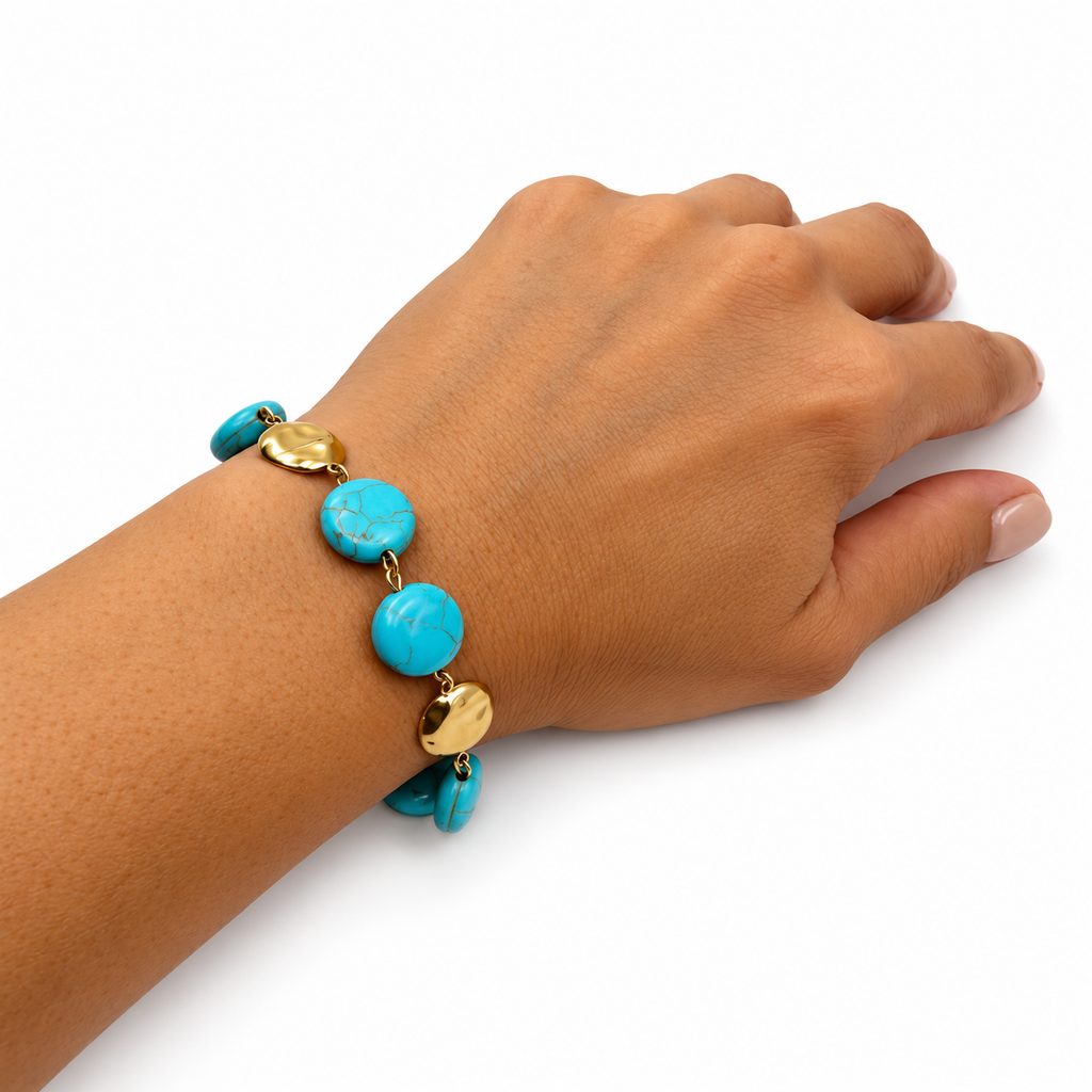  turquoise-blue beads and polished gold-toned metal charms, 